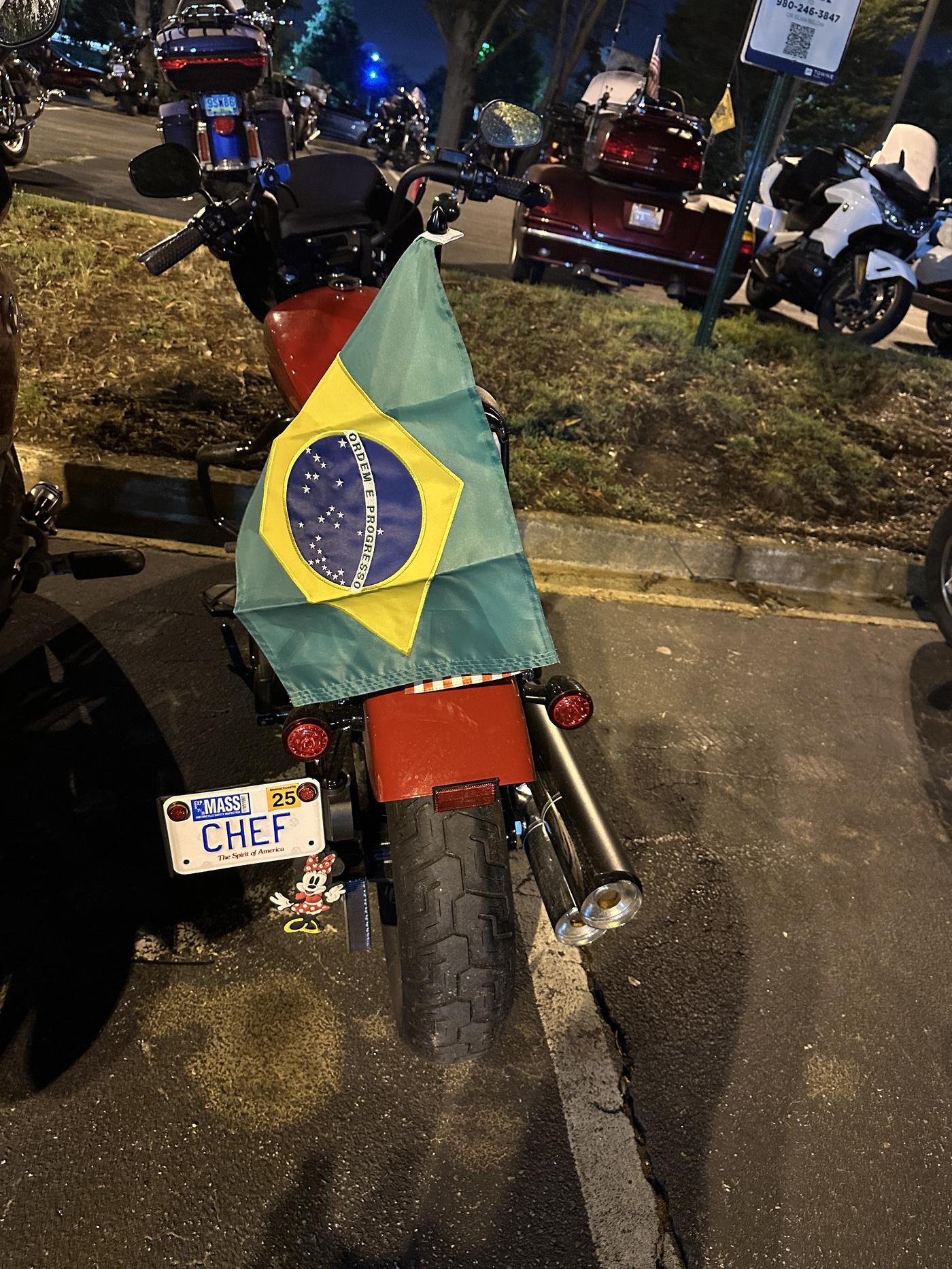 Chef with Brazil flag on a bike at the 2025 Ride 2 Remember in Charlotte, North Carolina